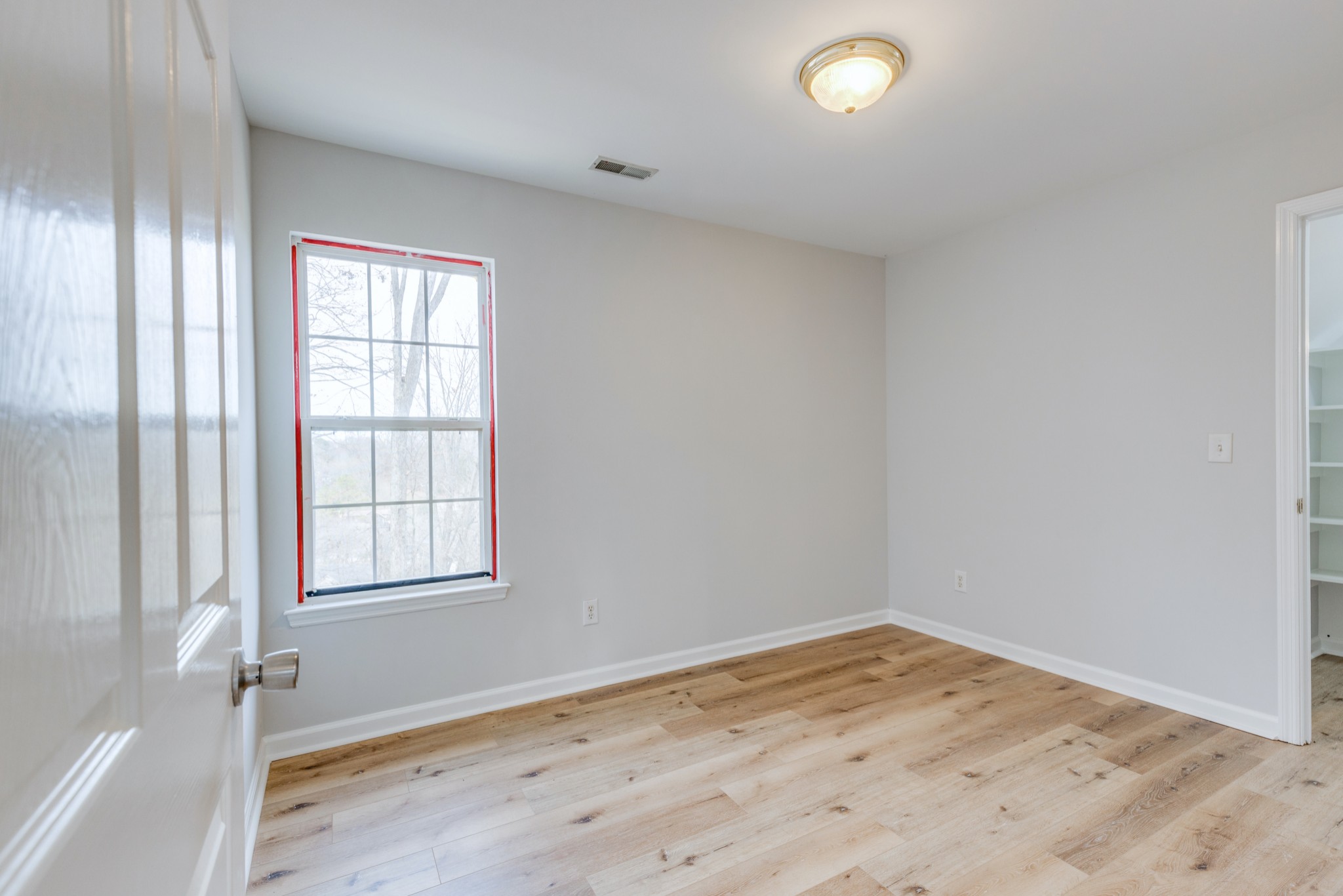 2829 Rader Ridge Court Antioch, TN 37013 - Photo 25 of 35 an empty room with wooden floor and windows