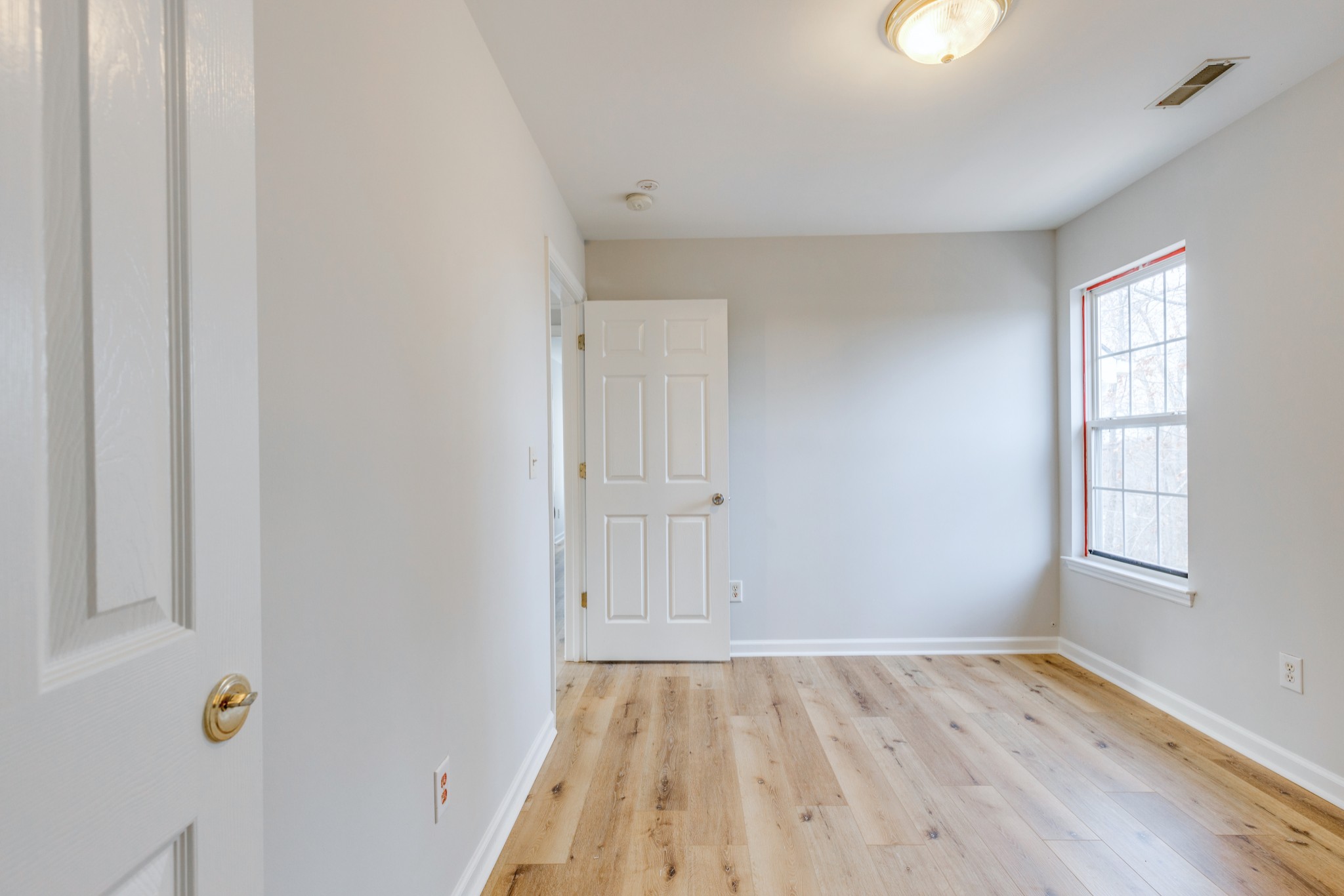 2829 Rader Ridge Court Antioch, TN 37013 - Photo 26 of 35 a view of an empty room with wooden floor and a window