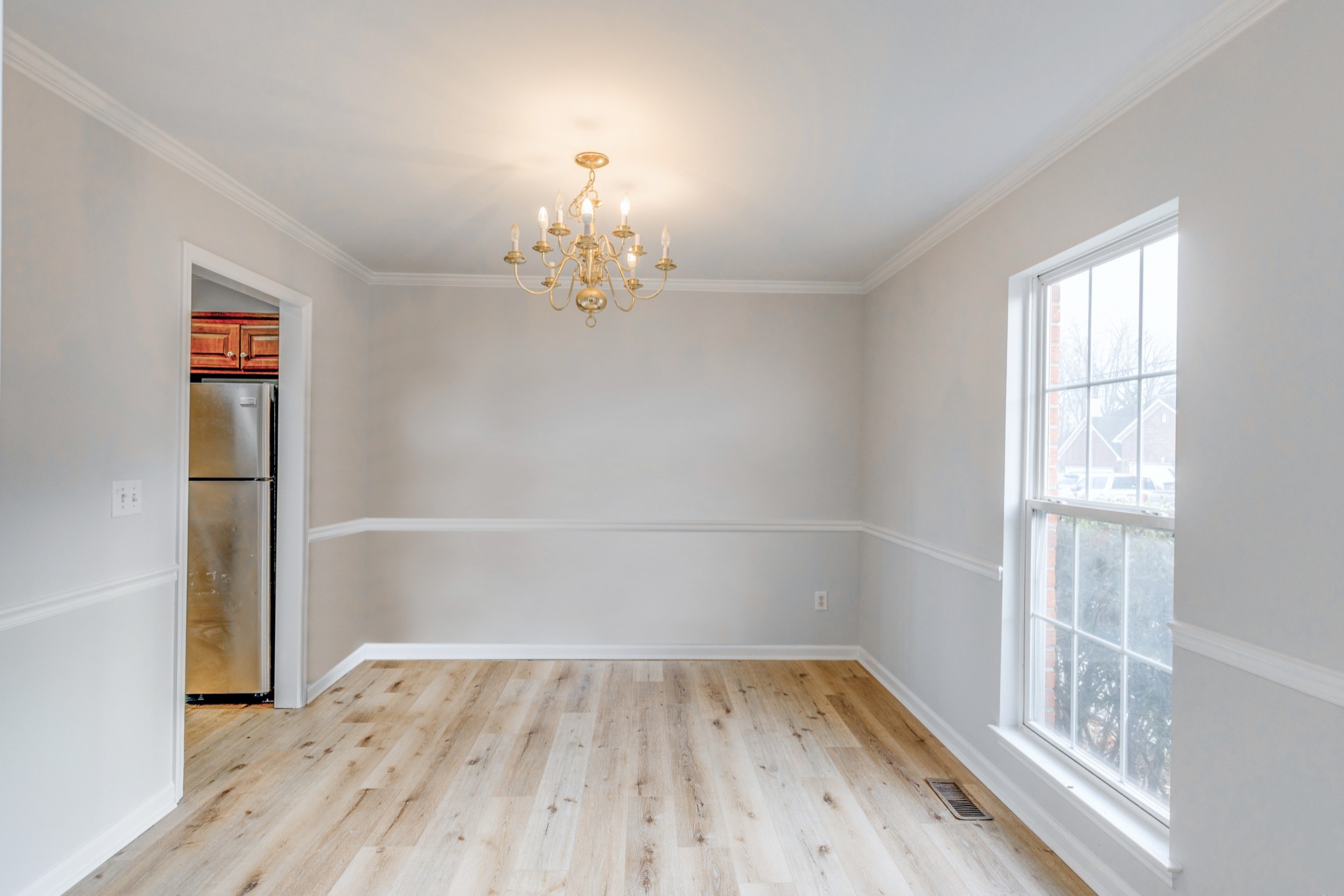 2829 Rader Ridge Court Antioch, TN 37013 - Photo 6 of 35 an empty room with wooden floor chandelier and windows