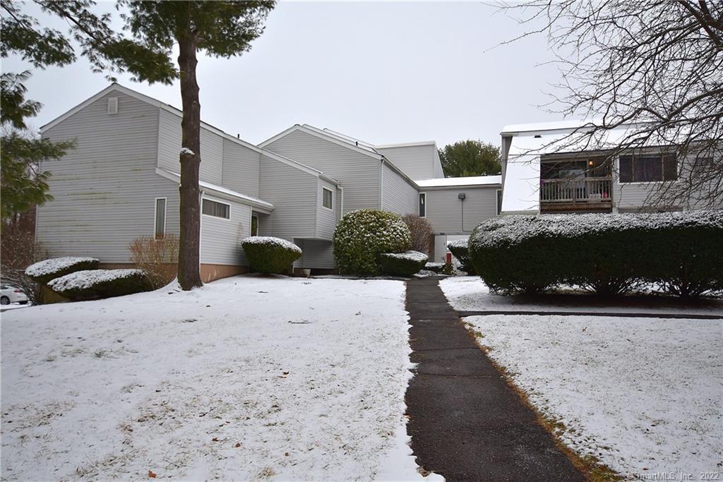 655 Talcottville Road, Unit 127 Vernon, CT 06066 - Photo 1 of 1 a front view of a house with a yard and garage