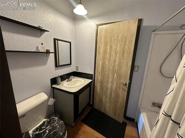 a bathroom with a toilet a sink and a shower