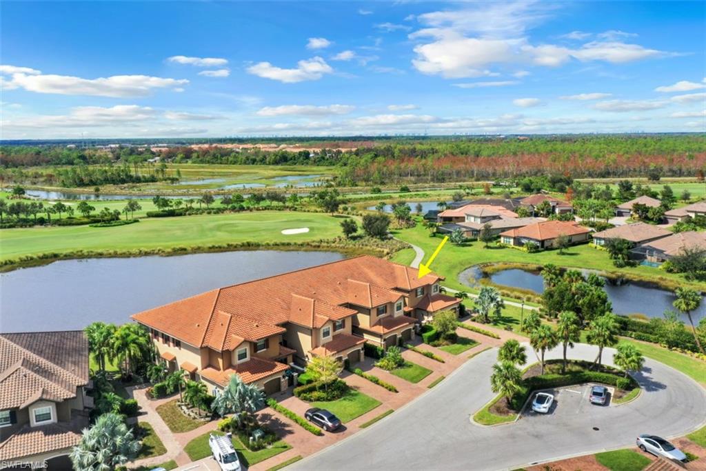 8776 Bellano Court, Unit 104 Naples, FL 34119 - Photo 1 of 34 an aerial view of a city with lots of residential buildings and mountain view in back
