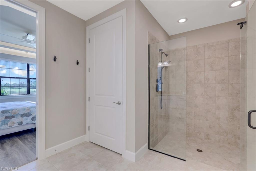 8776 Bellano Court, Unit 104 Naples, FL 34119 - Photo 12 of 34 a bathroom with a shower