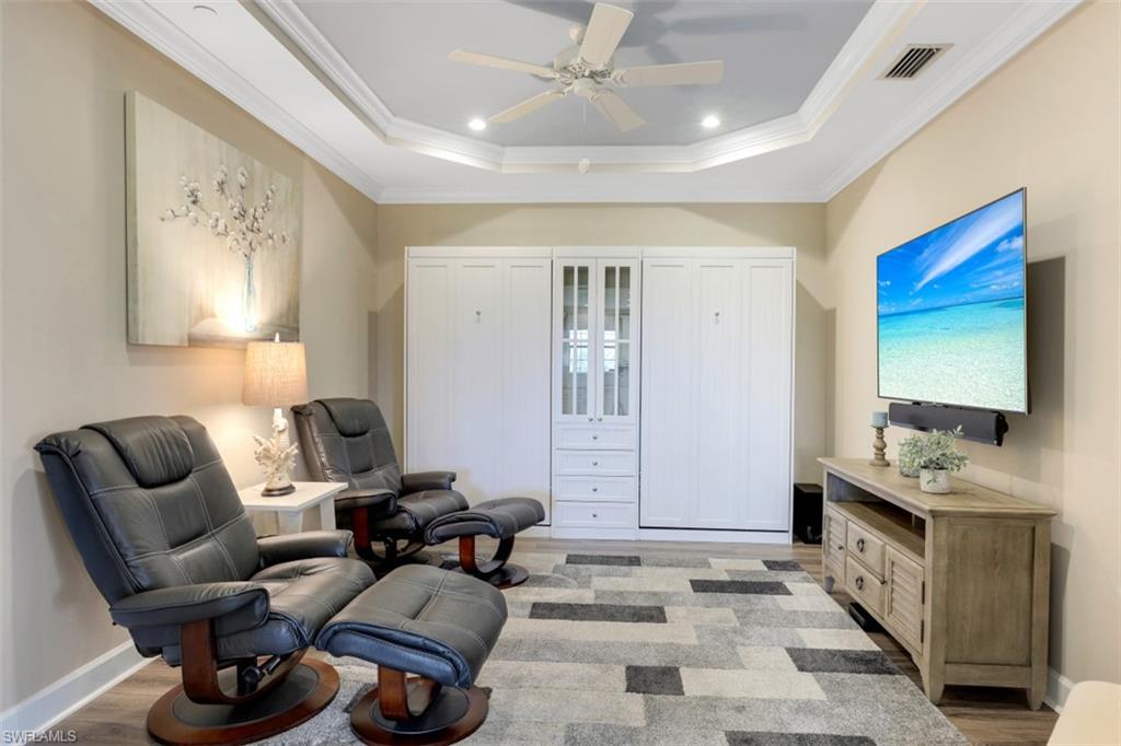 8776 Bellano Court, Unit 104 Naples, FL 34119 - Photo 16 of 34 a living room with furniture a flat screen tv and a couch