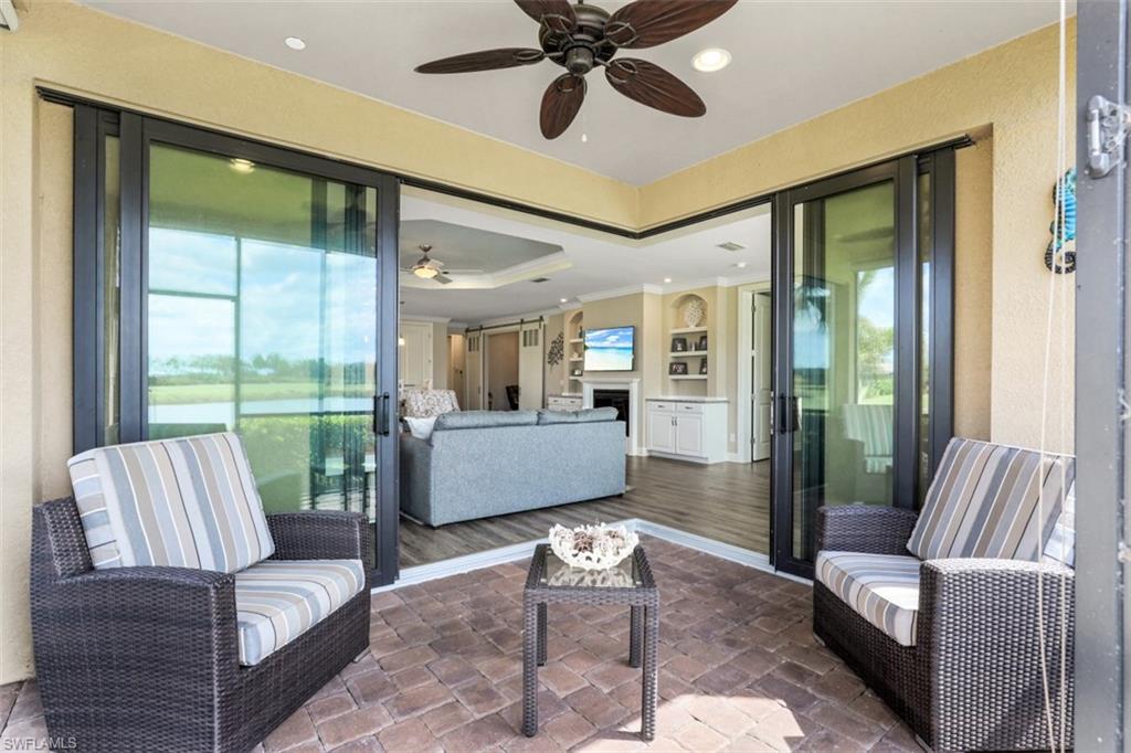 8776 Bellano Court, Unit 104 Naples, FL 34119 - Photo 19 of 34 a living room with furniture and a large window