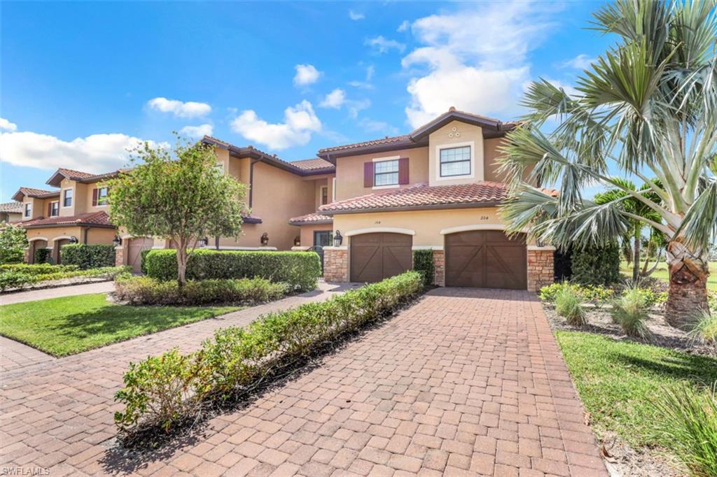 8776 Bellano Court, Unit 104 Naples, FL 34119 - Photo 20 of 34 a house view with a garden space