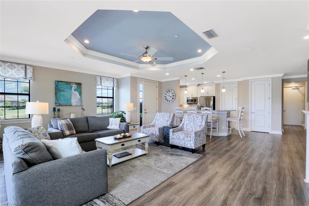 8776 Bellano Court, Unit 104 Naples, FL 34119 - Photo 3 of 34 a living room with furniture and wooden floor