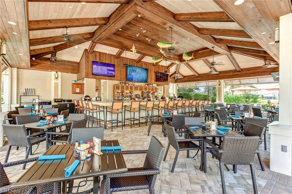 8776 Bellano Court, Unit 104 Naples, FL 34119 - Photo 32 of 34 a view of a tables and chairs in patio