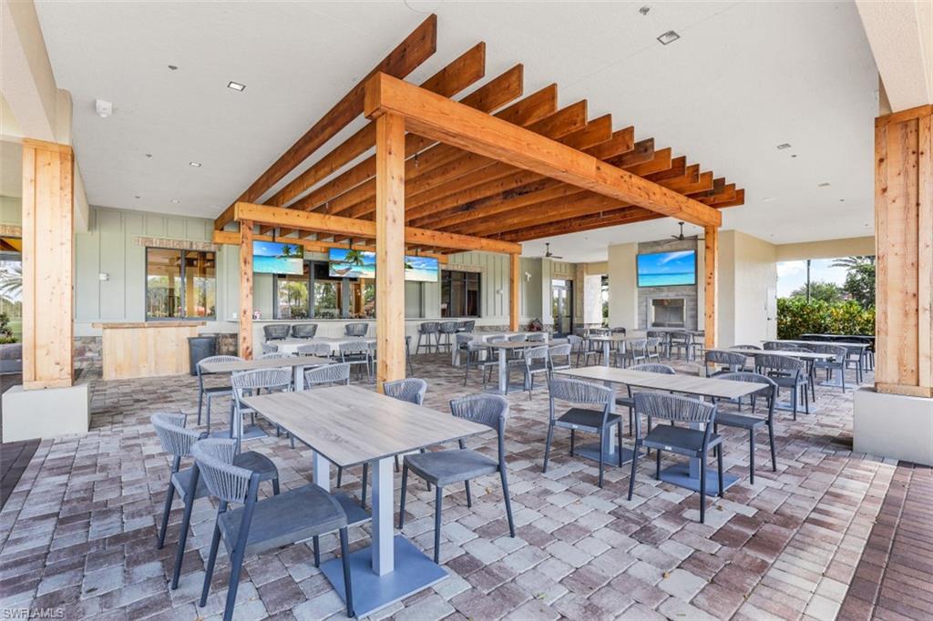 8776 Bellano Court, Unit 104 Naples, FL 34119 - Photo 33 of 34 a view of a dinning table and chairs in the patio