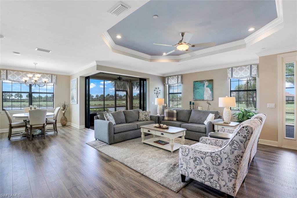 8776 Bellano Court, Unit 104 Naples, FL 34119 - Photo 4 of 34 a living room with furniture and a large window
