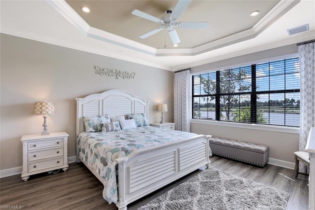 8776 Bellano Court, Unit 104 Naples, FL 34119 - Photo 9 of 34 a bedroom with a bed and a window