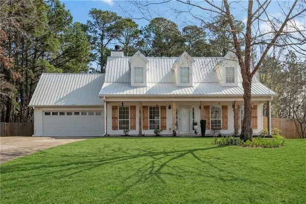 a front view of a house with garden
