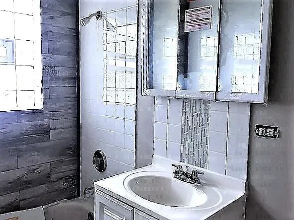 a bathroom with a sink a mirror and a window