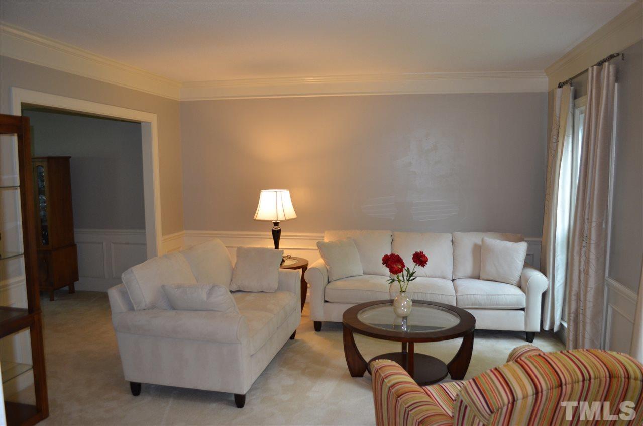 2108 Osprey Circle Raleigh, NC 27615 - Photo 2 of 15 a living room with furniture a lamp and a window