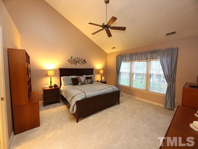 2108 Osprey Circle Raleigh, NC 27615 - Photo 7 of 15 a bed room with a bed mirror and a window