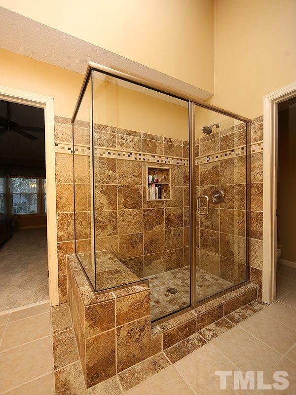 2108 Osprey Circle Raleigh, NC 27615 - Photo 9 of 15 a bathroom with a shower and a glass door