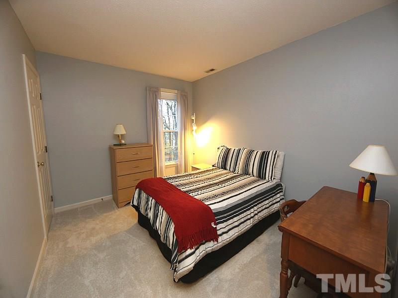 2108 Osprey Circle Raleigh, NC 27615 - Photo 10 of 15 a bedroom with a bed and a table in it