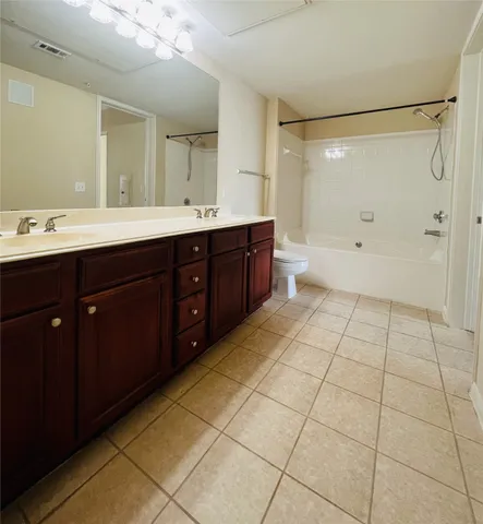 a spacious bathroom with a double vanity sink mirror and a shower