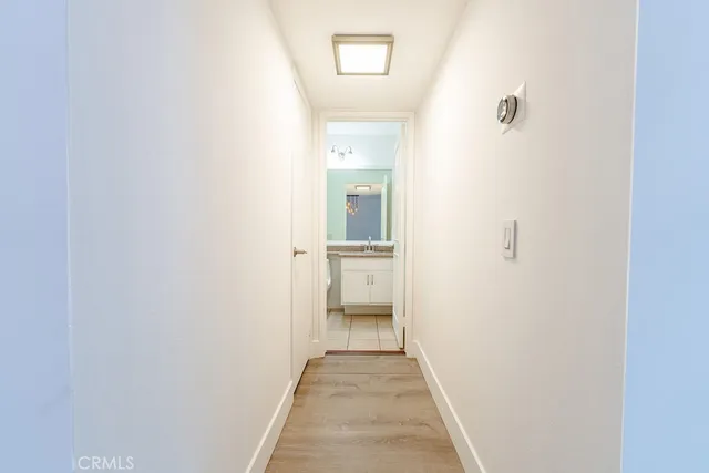 a view of entryway and hall with wooden floor
