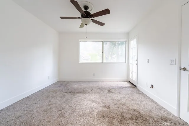 a view of a hallway with wooden floor and a living room