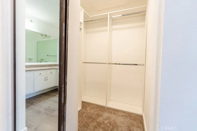 a bathroom with a granite countertop sink double and mirror