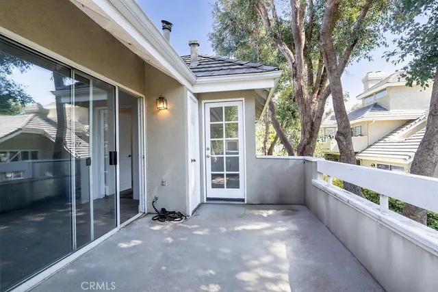 a view of a livingroom with wooden floor and a fireplace