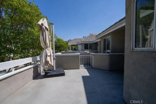 a balcony with furniture and a potted plant