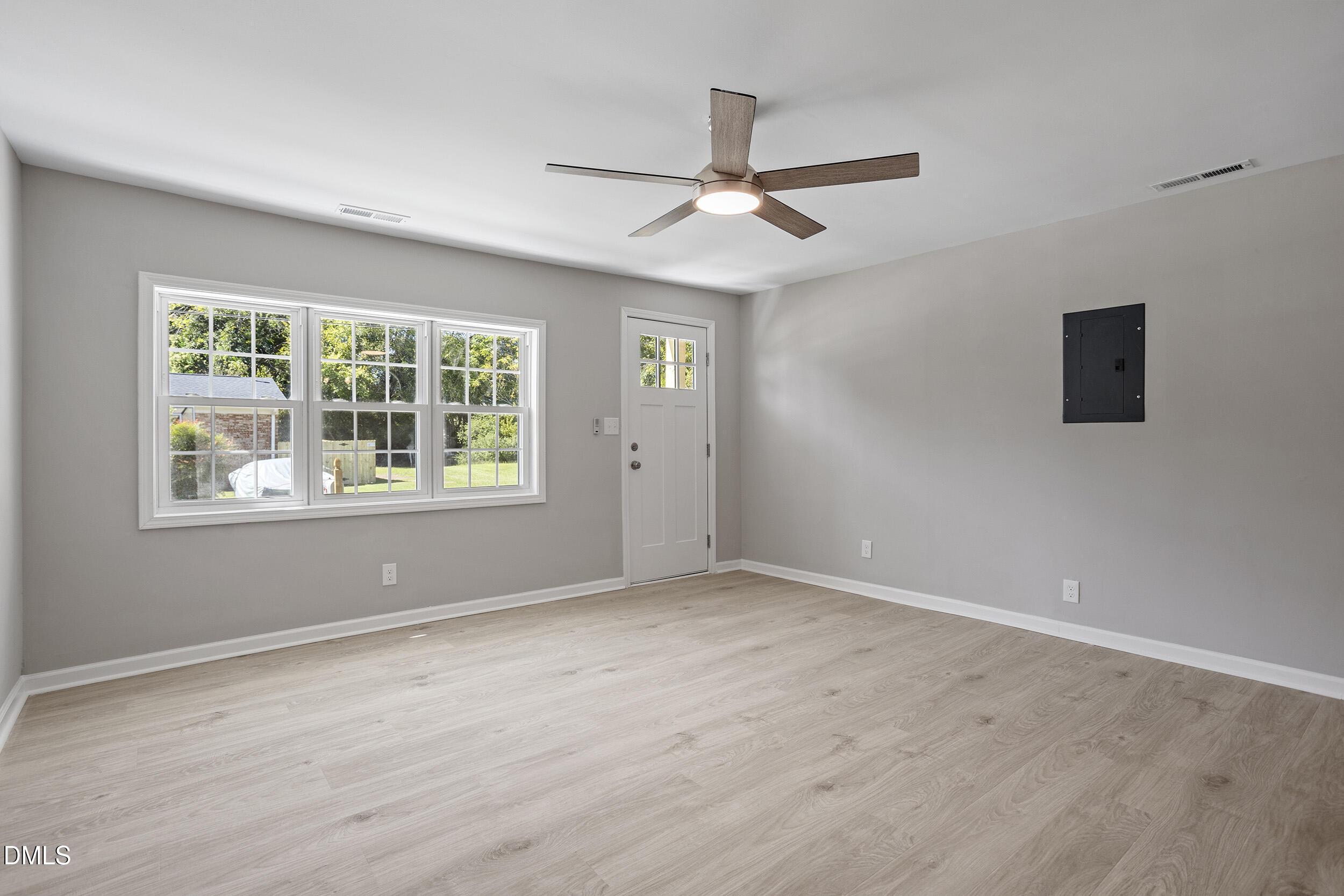 604 East Townsend Street Dunn, NC 28334 - Photo 5 of 27 a view of an empty room with a window and wooden floor