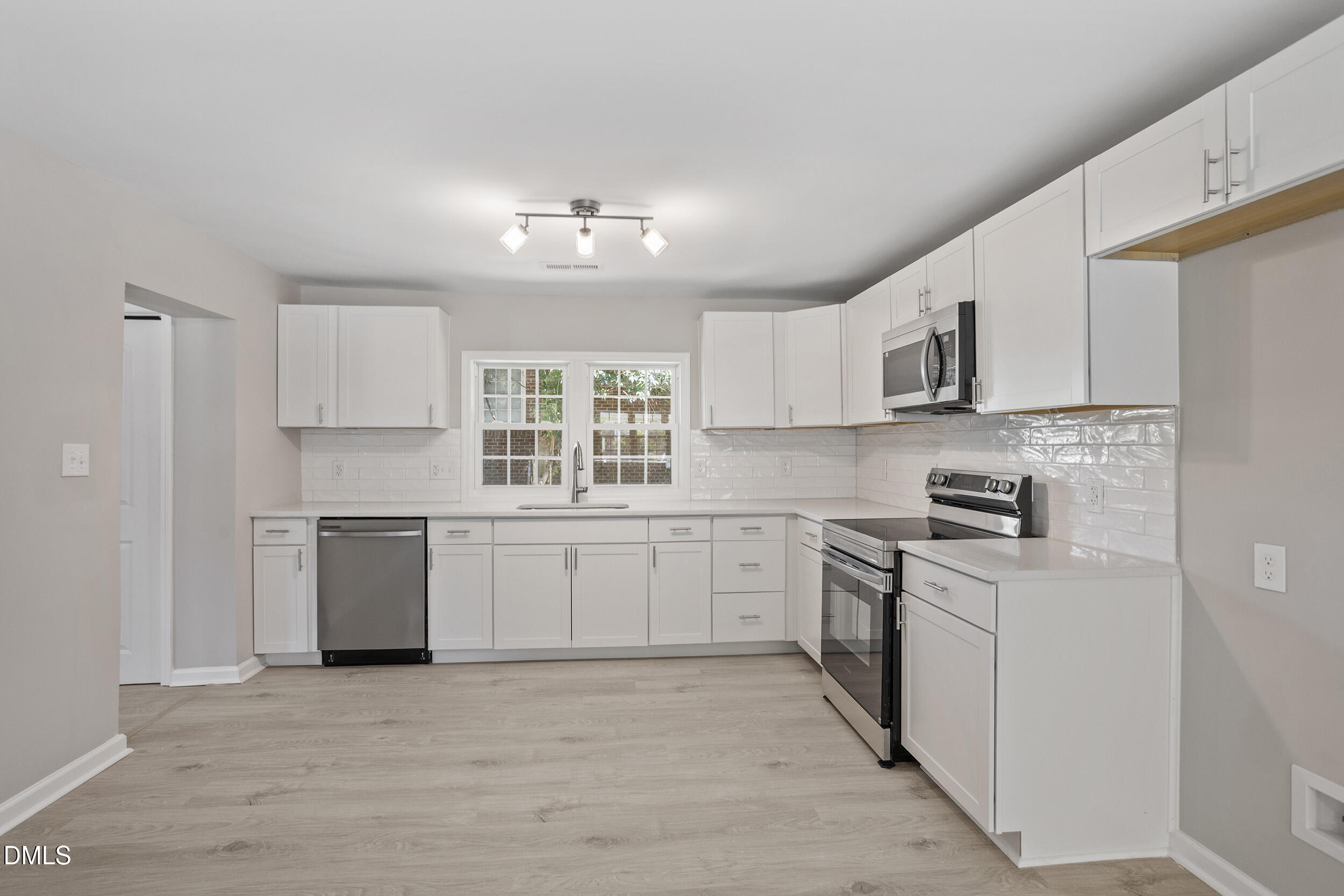 604 East Townsend Street Dunn, NC 28334 - Photo 10 of 27 a kitchen with cabinets appliances a sink and a window