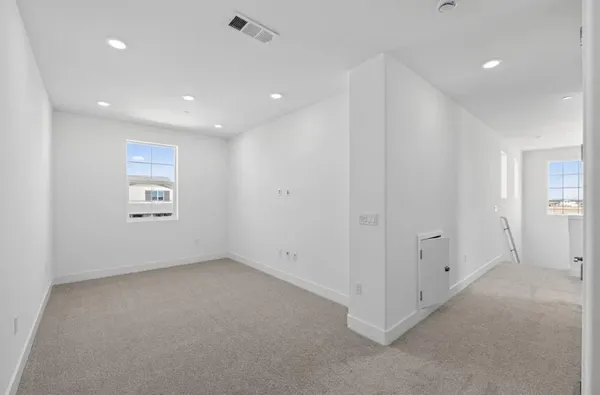 a large kitchen with stainless steel appliances kitchen island a stove a sink dishwasher and a oven with white cabinets