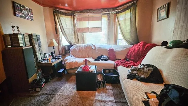 a bedroom with furniture and a window