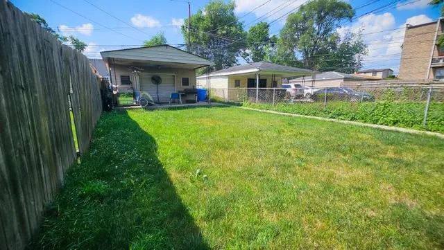 a view of a house with a backyard and a patio