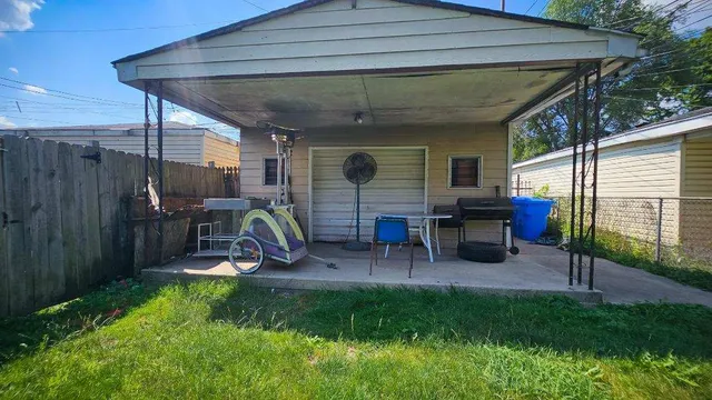a view of a porch with furniture and a yard
