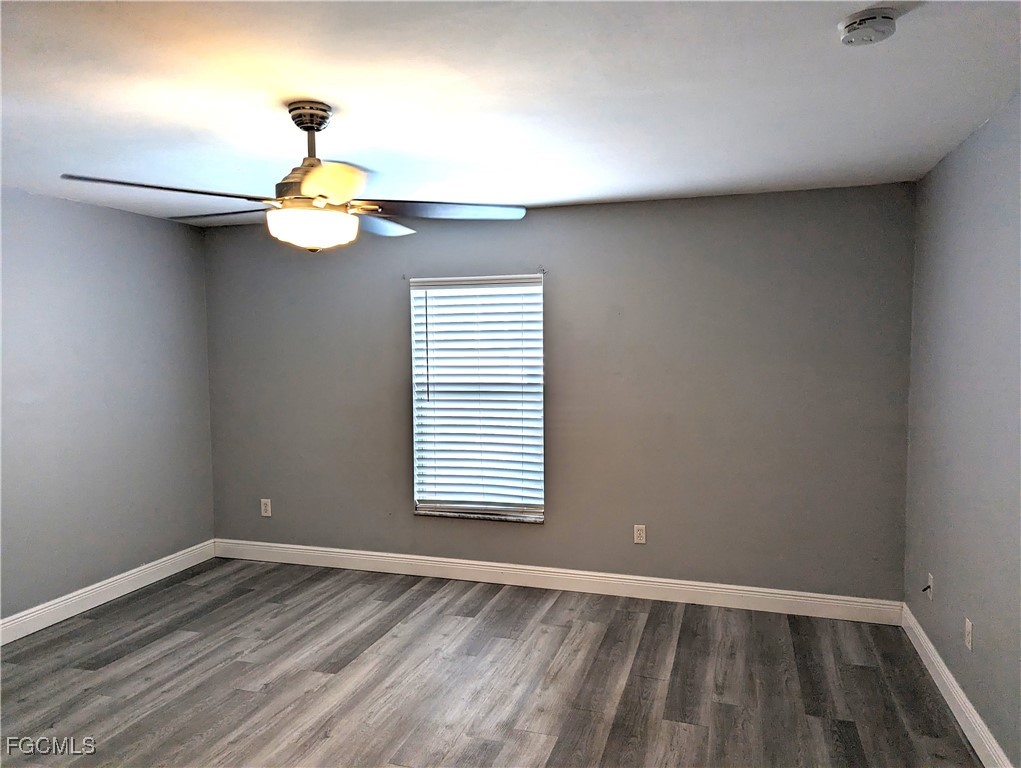 2311 Southwest 16th Terrace Cape Coral, FL 33991 - Photo 21 of 23 a view of an empty room with a window and wooden floor