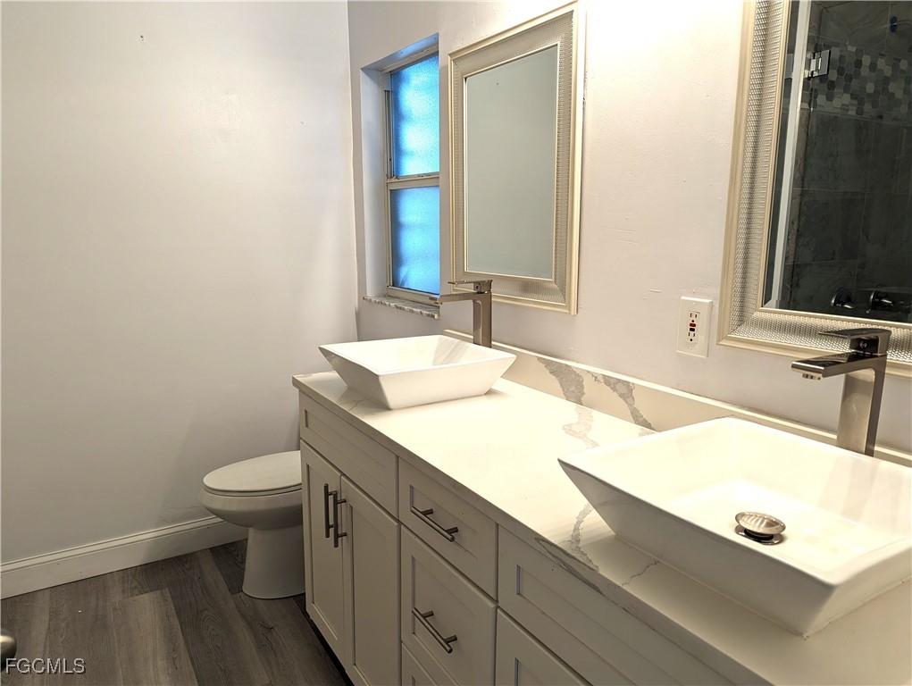2311 Southwest 16th Terrace Cape Coral, FL 33991 - Photo 22 of 23 a bathroom with a sink and a mirror