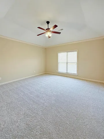 an empty room with windows and ceiling fan view