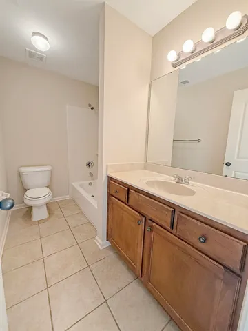 a view of a room with a ceiling fan and window