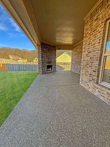 a view of empty room with floor to ceiling window and yard