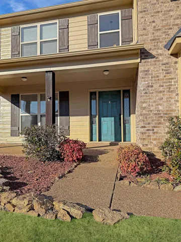 a view of a house with potted plants