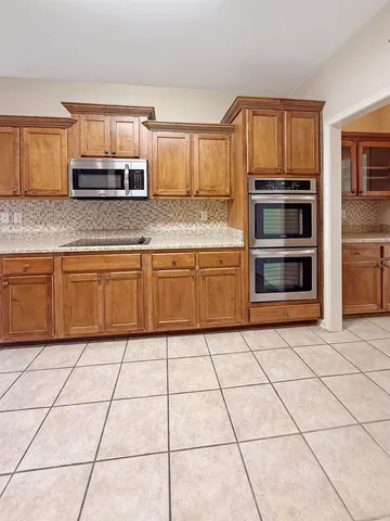 a kitchen with granite countertop a stove a sink and a granite counter top