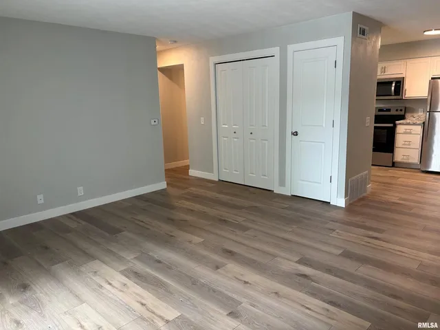 a view of a kitchen with wooden floor and a sink