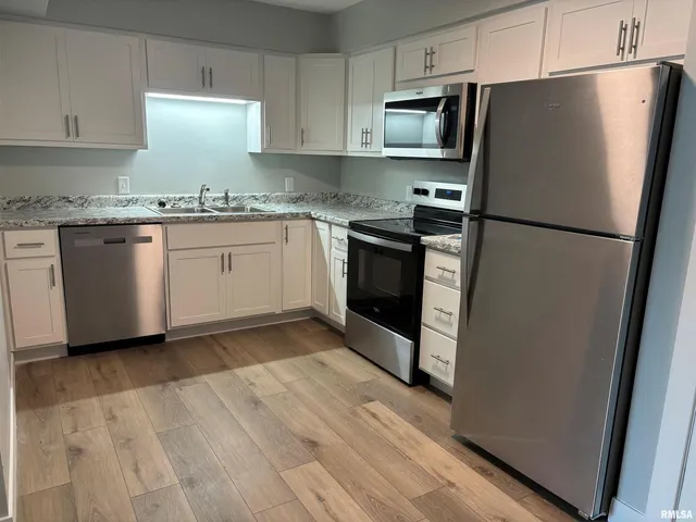 a kitchen with a refrigerator sink and stove