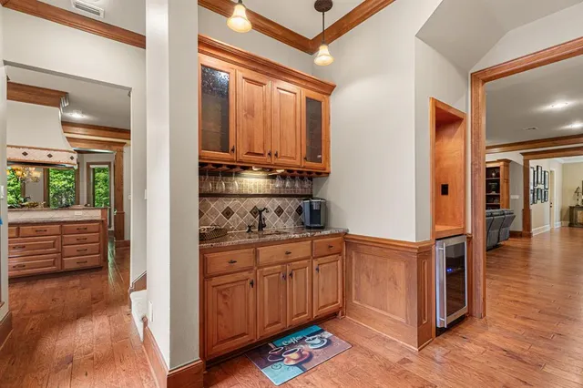a kitchen with stainless steel appliances granite countertop a refrigerator and a stove top oven