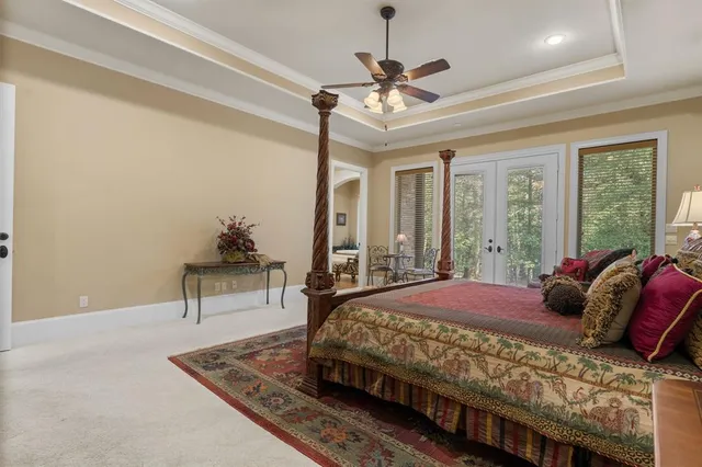 a bedroom with a bed and a chandelier