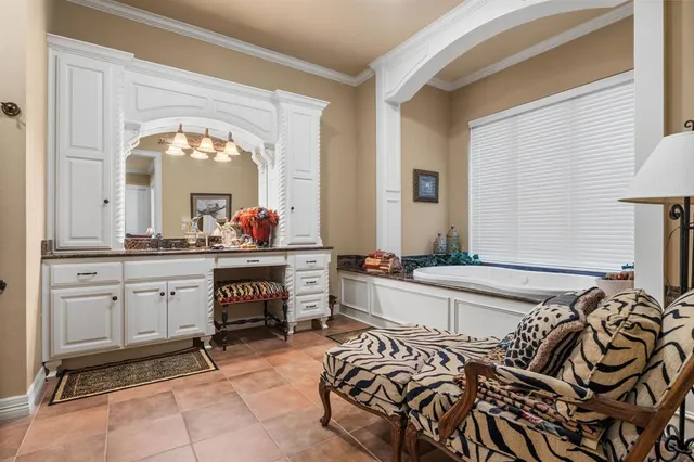 a bedroom with a bed and a mirror on the dresser