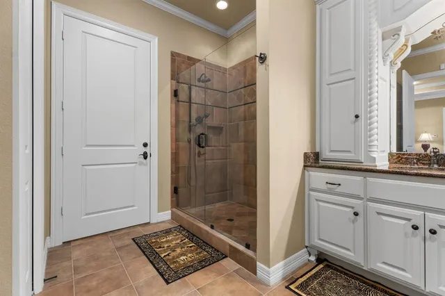 a bathroom with a shower a mirror and a sink