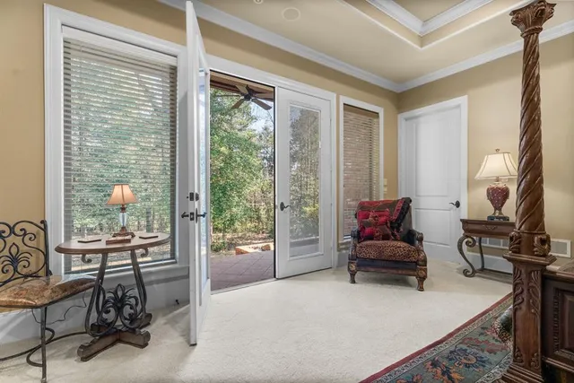 a living room with furniture and floor to ceiling windows