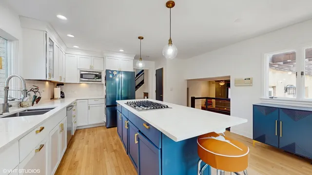 a kitchen with a sink stove and refrigerator