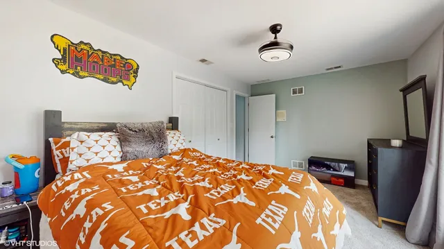 a bedroom with a bed and a painting on the wall