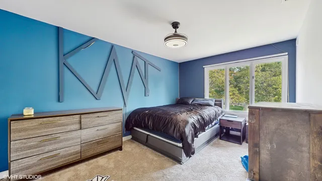 a bed sitting in a room next to a window